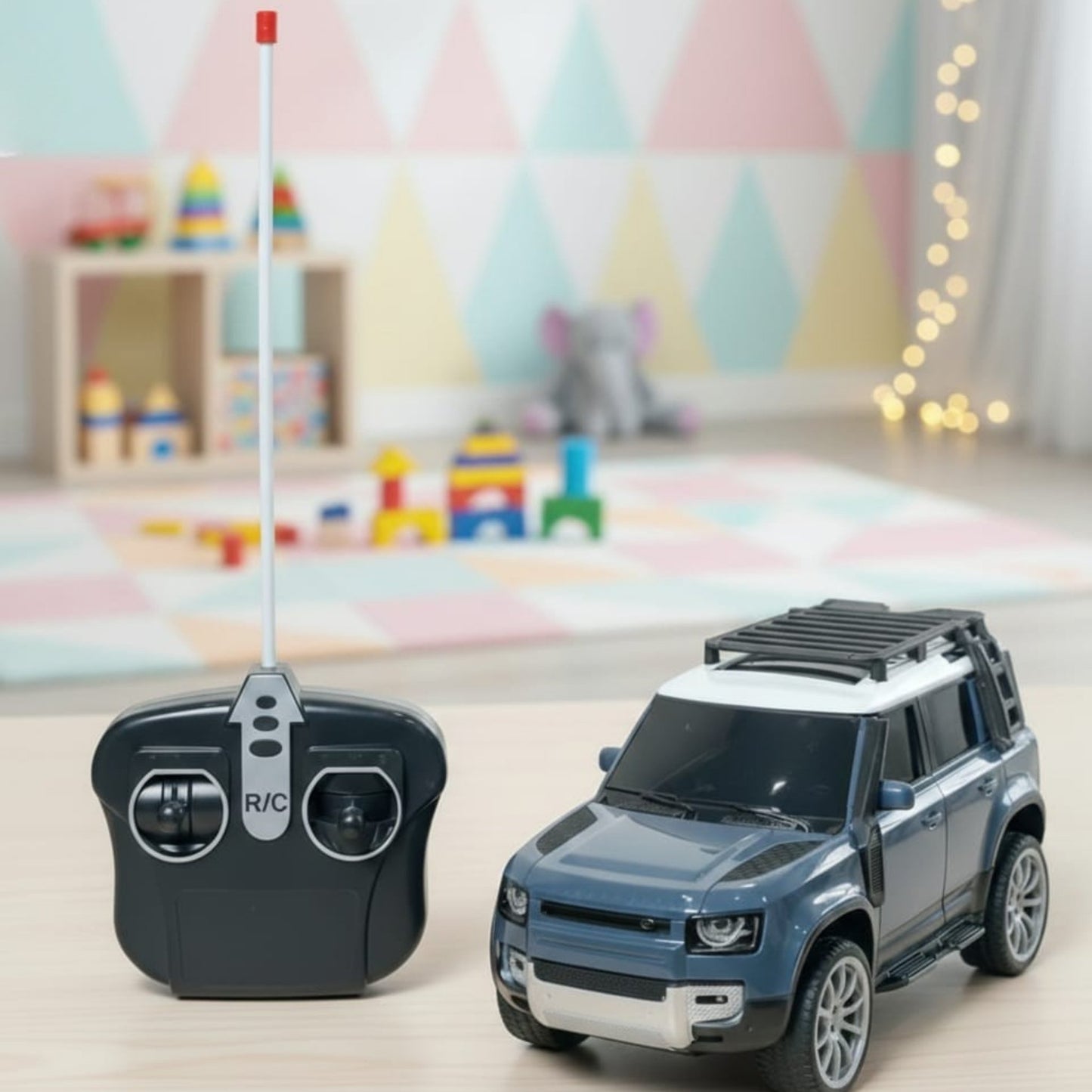 Toy car and remote control on a surface with a colorful, playful background